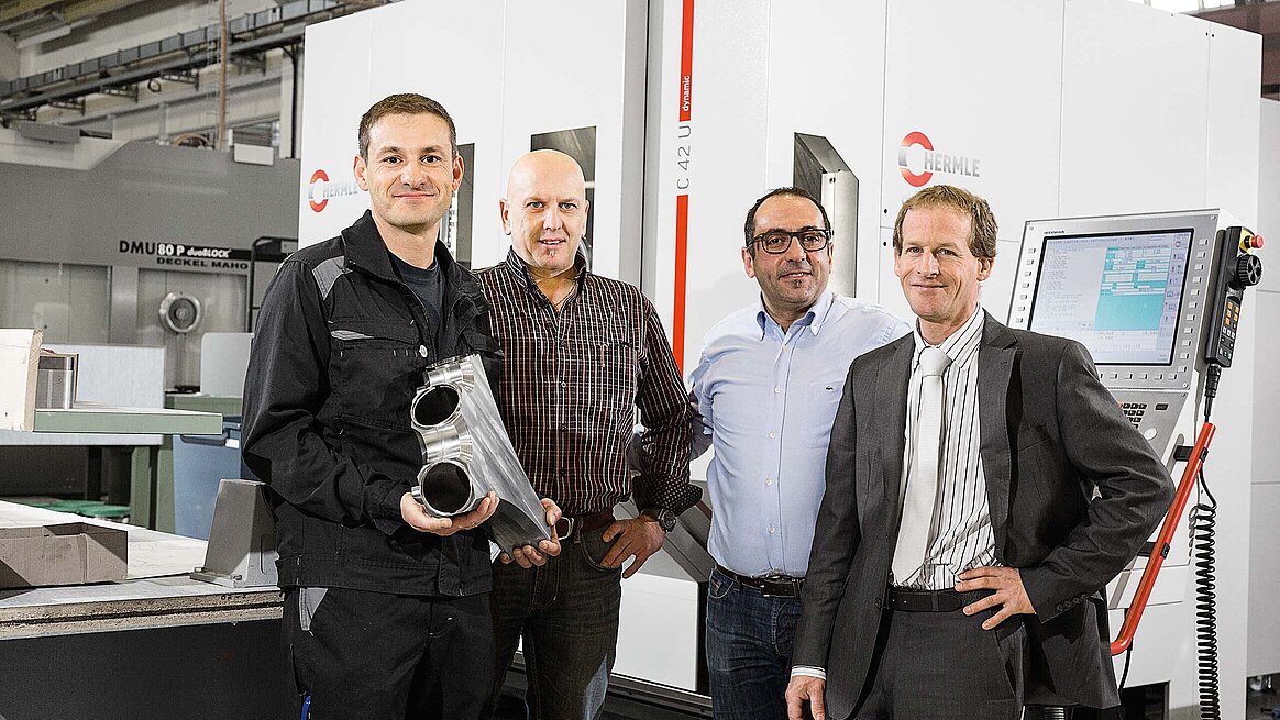 Von links nach rechts den Maschinenbediener Christophe Delorme, den Werkstattmeister Jean-Marie Geisser, den Leiter Mechanische Fertigung im MME, Said Atieh, alle drei vom CERN in Meyrin, und Martin Tschupp, Verkaufsingenieur bei der Hermle (Schweiz) AG