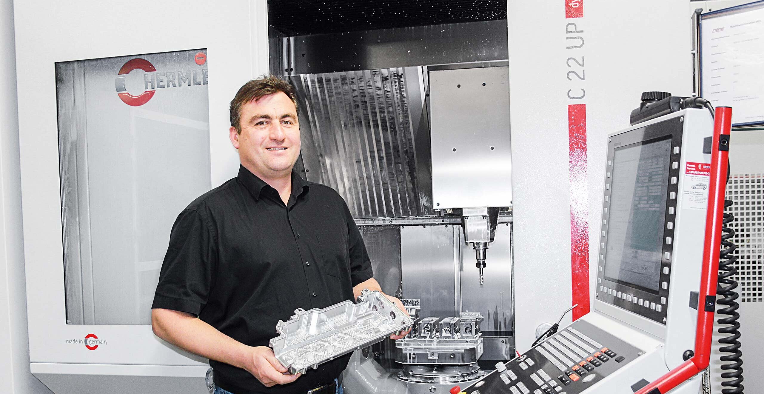 Johann Dietl, Head of the Mechanics Division at Zollner Elektronik AG at the main Zandt plant in front of the compact C 22 UP machining centre machining area