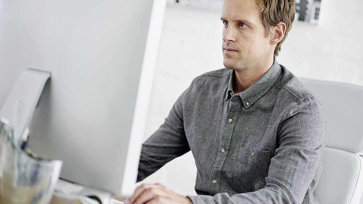 Mitarbeiter bedient PC mit CAD CAM System