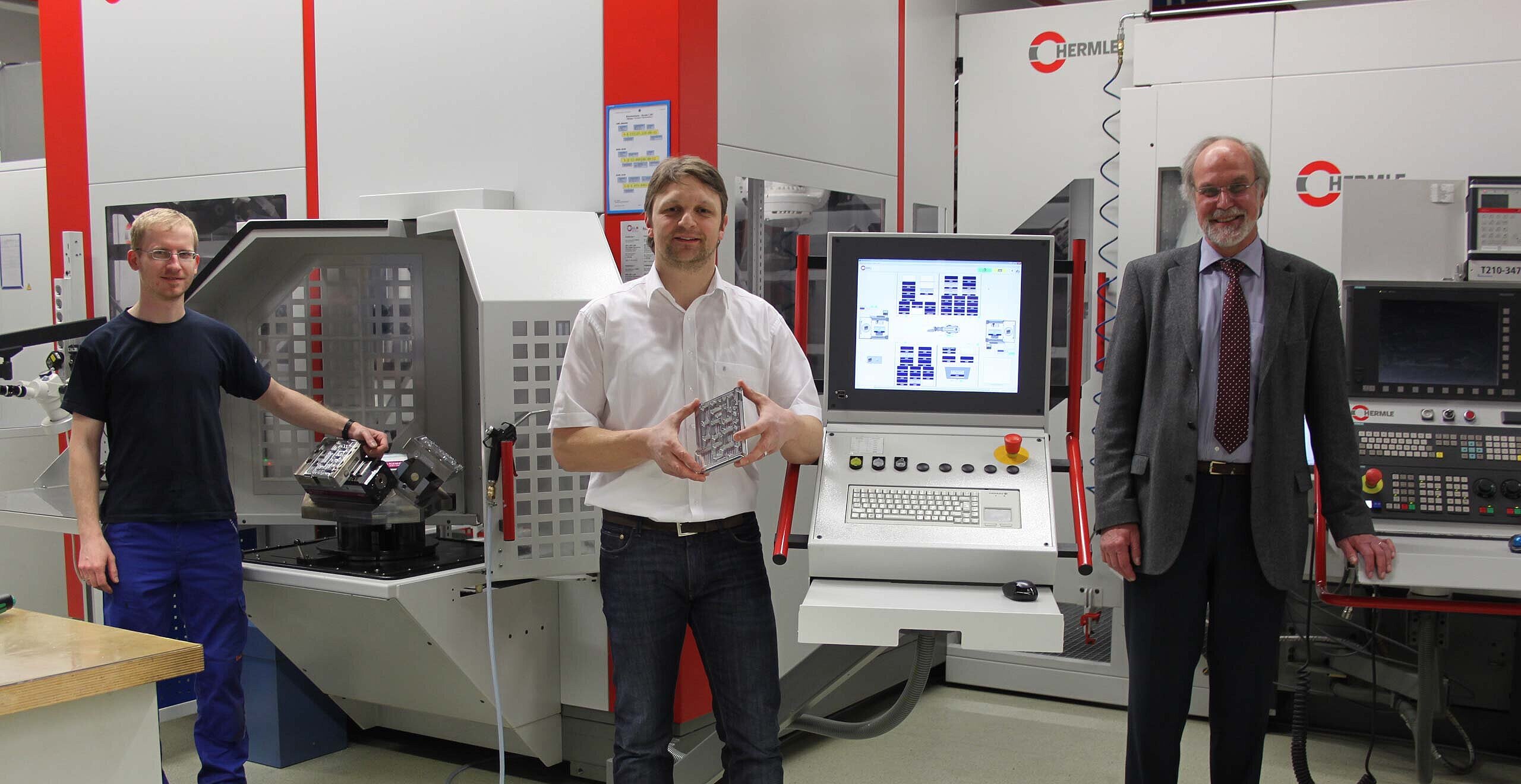 Martin Blüml, Machine/System Operator, Andreas Bauer, Director of CNC Vertical Milling, both from Rohde & Schwarz Teisnach plant, and Manfred Moser, Sales Representative of Hermle + Partner Vertriebs GmbH