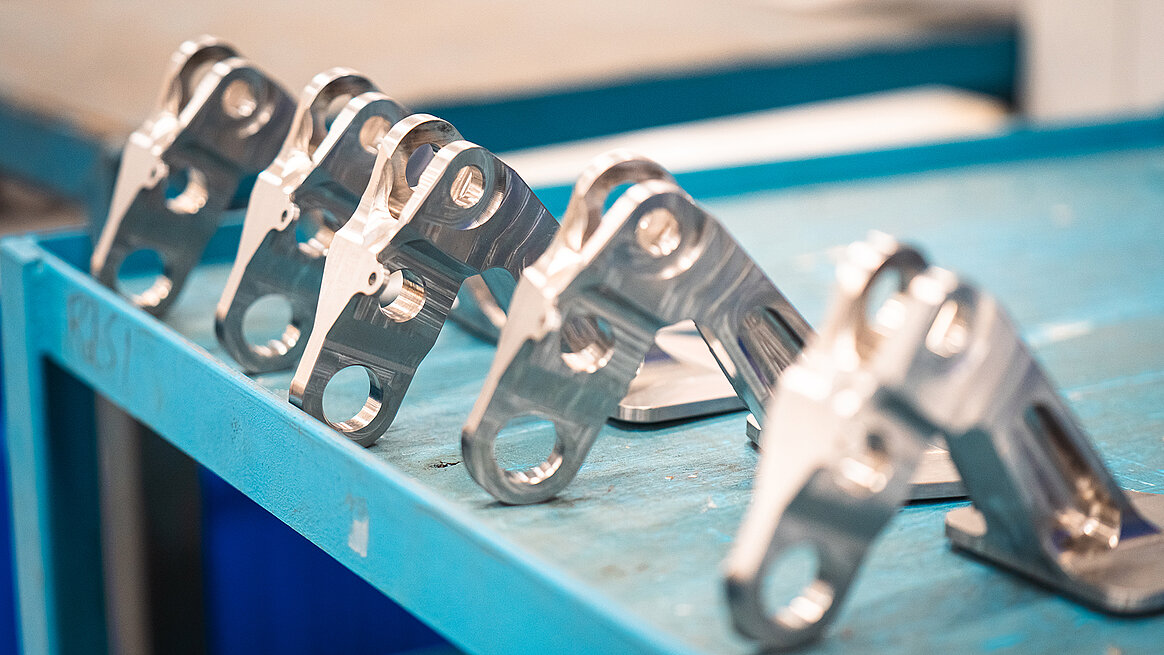 Aluminum billet structural shifter arms machined on the HERMLE 5-axis CNC machine at Seyer Industries.